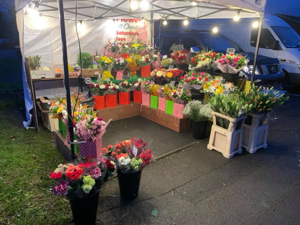 flower stall lit in the evening